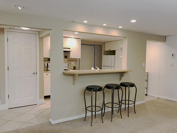 Blue tape on wall in the background outlines the access door area to be removed and that leads to the second bedroom/flex room with fireplace.