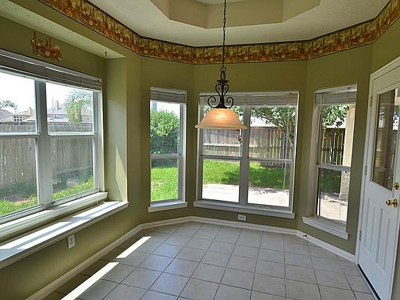 The breakfast area is very spacious and surrounded by a wall of windows with lovely views of the backyard and patio.