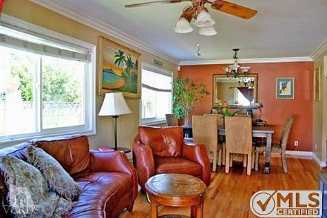 Family Room with hardwood flooring, smooth ceilings, Pella dual pane windows and crown molding.