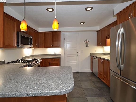 Kitchen has been updated with Stainless steel appliances, breakfast bar and designer pendant lights