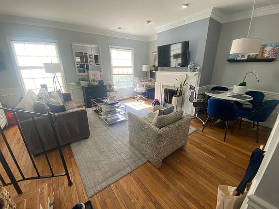 Hardwood floors and windows light up the living area.