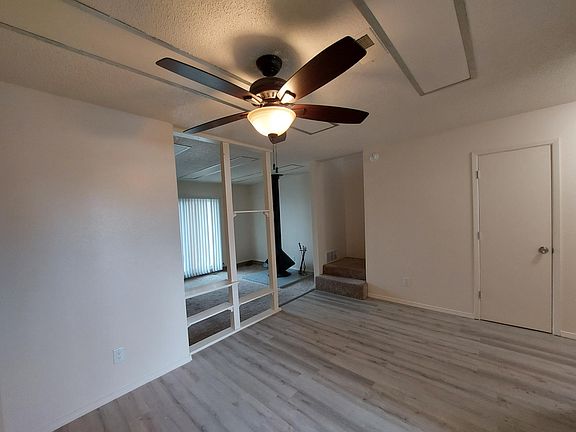 Dining room leading to living room, stairway, in-unit storage closet.
