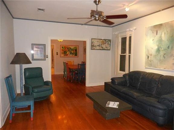 Living room, standing in the front door with dinning room and sliver of door to kitchen in the back ground.