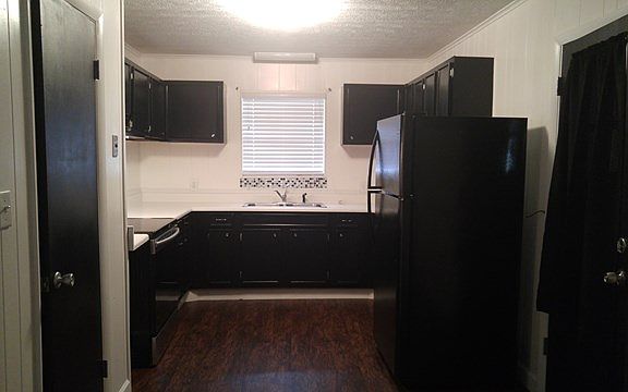 Large kitchen with smooth top stove, range hood, dishwasher and refrigerator.
