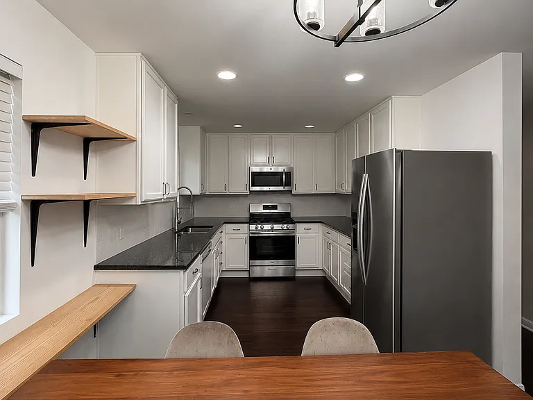 Updated white kitchen with all kitchen appliances.