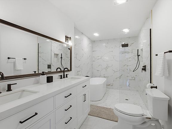 Primary bath: just fully renovated, expansive walk in shower, spa-like wet-room with free standing tub and luxury rain shower.