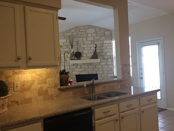 New granite counter tops, custom travertine backsplash