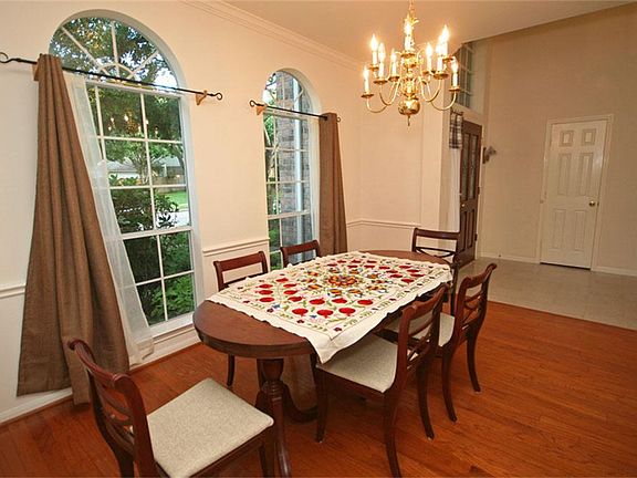 There is a hardwood floor in the dining room and two arched windows.