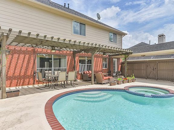 Enjoy this backyard retreat on a hot summer's day.  Pool, hot tub, shaded patio and barbeque grill!