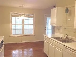 Kitchen with dine-in space which accommodates standard table and chairs.