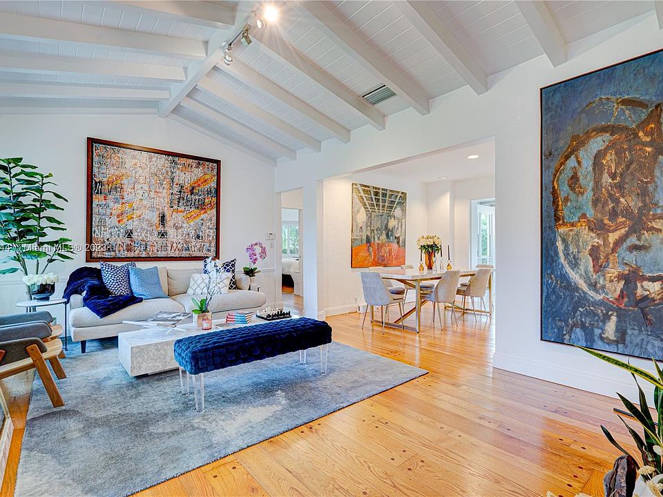 Welcoming living room with vaulted wood ceilings, hand-pegged wood floors and art deco fireplace open to Dining room, kitchen and FR/sunroom