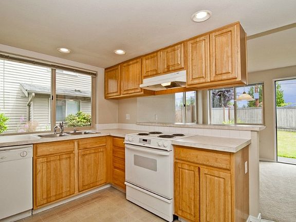 See the kitchen and dining room as you enter! You can see the door open to the spacious fully fenced rear yard.