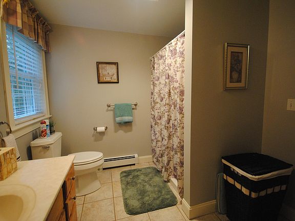 Bath with current tenant furnishings. Vanity is now painted gry