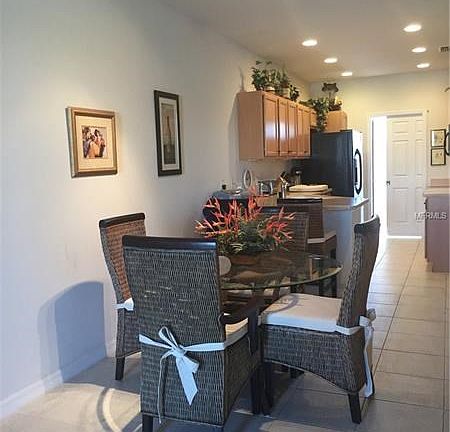 Dining area, breakfast bar, galley kitchen and lots of overhead lighting.