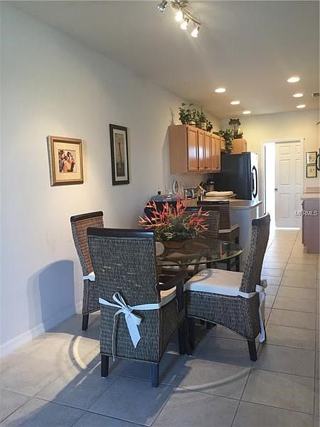 Dining area, breakfast bar, galley kitchen and lots of overhead lighting.