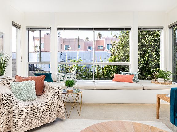 Custom 15' window seat with ocean-view nook for reading or sunset watching, and hidden storage.
