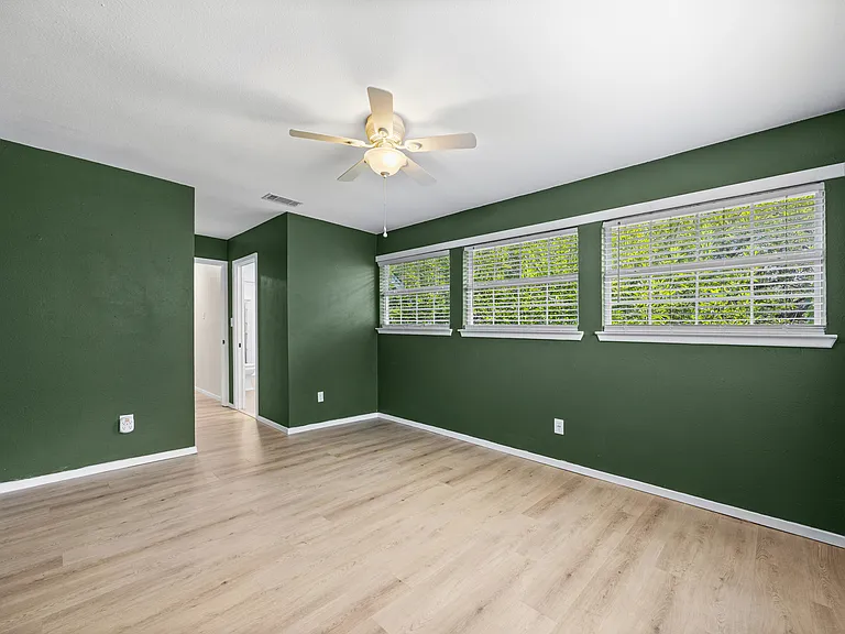 Primary bedroom upstairs with lots of natural light and two walk-in closets for ample storage.
