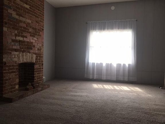 Bedroom with a decorative fireplace