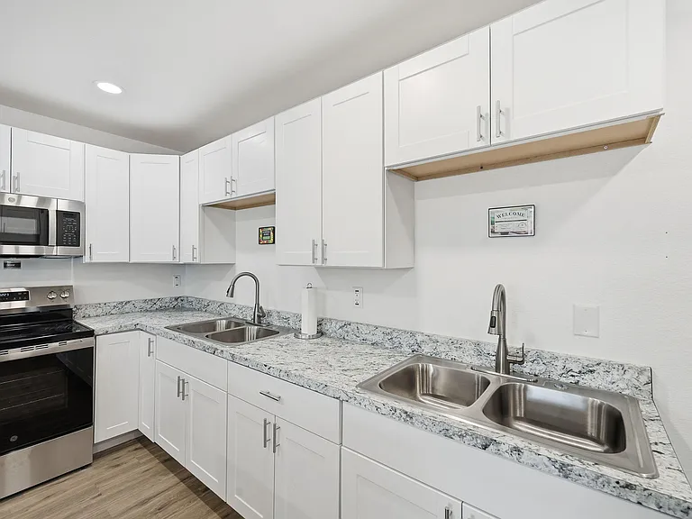 Fully renovated open concept kitchen w/ 3 fridges, 2 stoves, 2 sinks, 2 microwaves