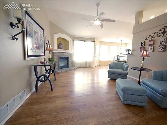 More of living room area with gas fireplace and walk-out to rear deck