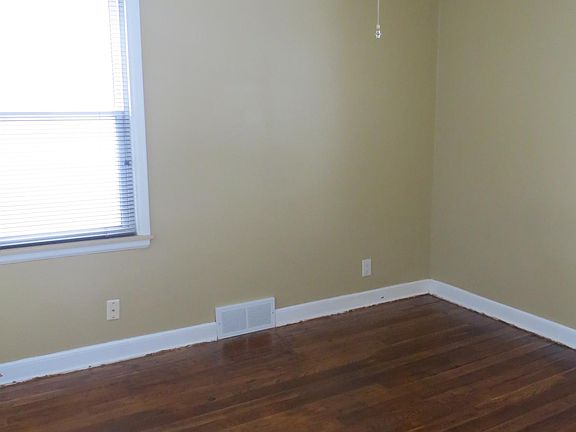 Main floor bedroom has hardwood floors, ceiling fan.