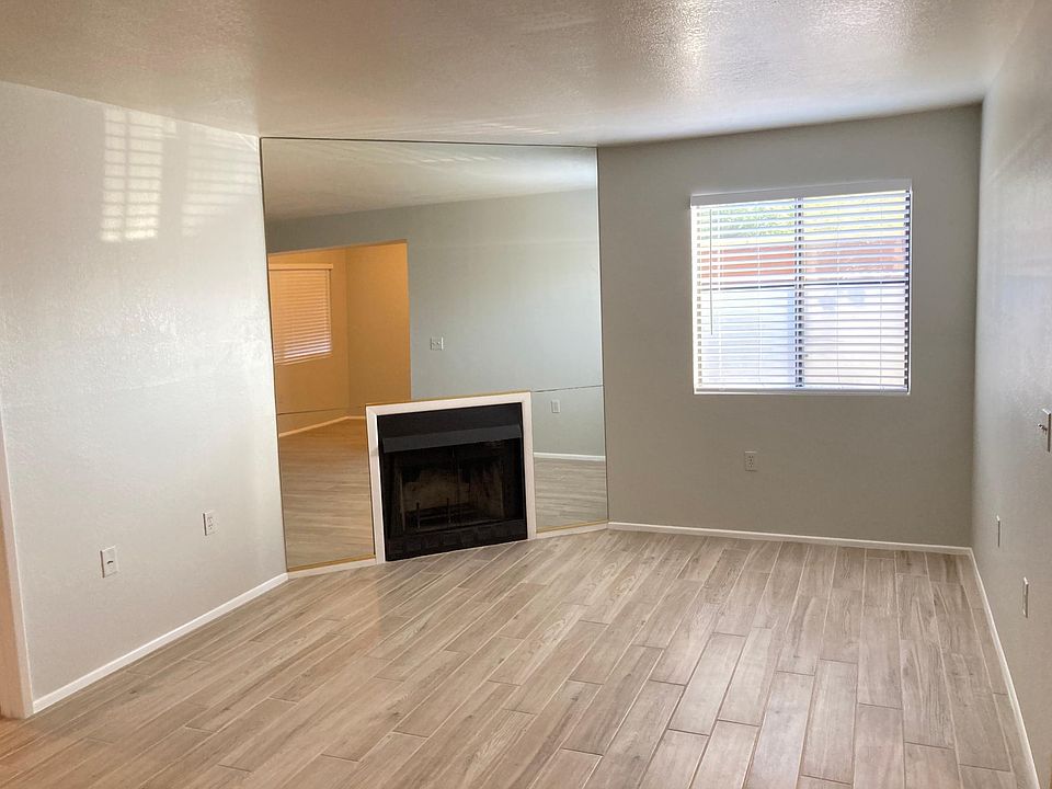 Living room with wood burning fireplace.