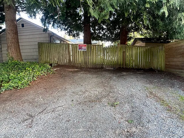 Two private parking spaces outside the fenced backyard.