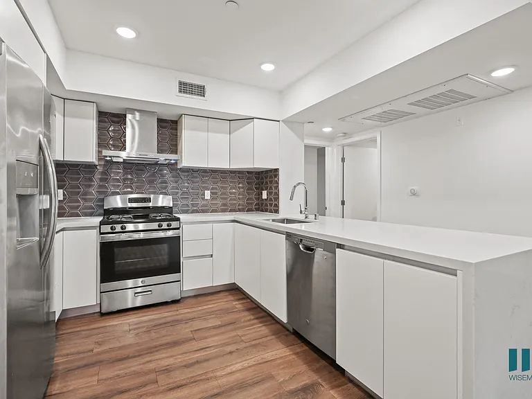 Open-Concept Kitchen with Energy-Efficient Appliances and Countertop Bar