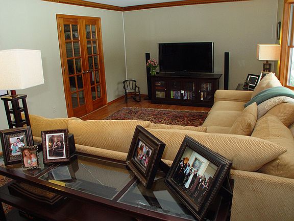 Living room features laminated flooring, French doors to FR and bay window