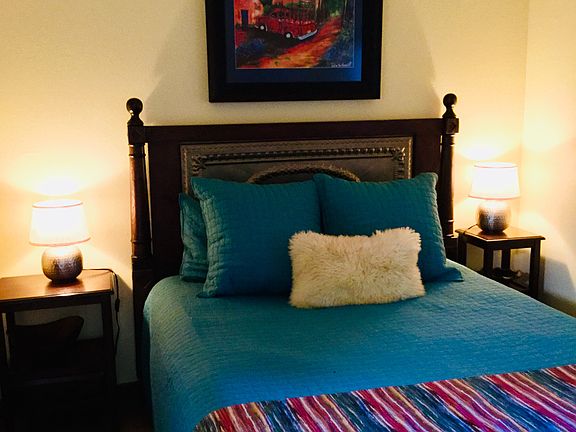 Qn size bed sleeps 1-2. 2 night stands, 1 dresser, tasteful artwork and bedding linens. Sheepskin rugs on hardwood floors.