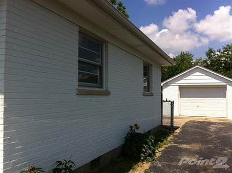Black top driveway with gate.