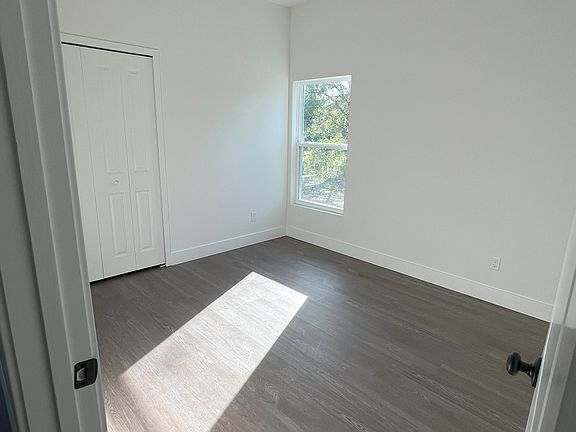 One of the three front bedrooms. REMOTE CONTROLLED CEILING FANS WILL BE ADDED TO EACH BEDROOM.