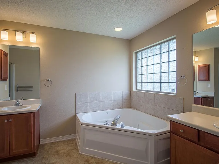 Primary bathroom #1 boasts double sinks and jetted soaker tub