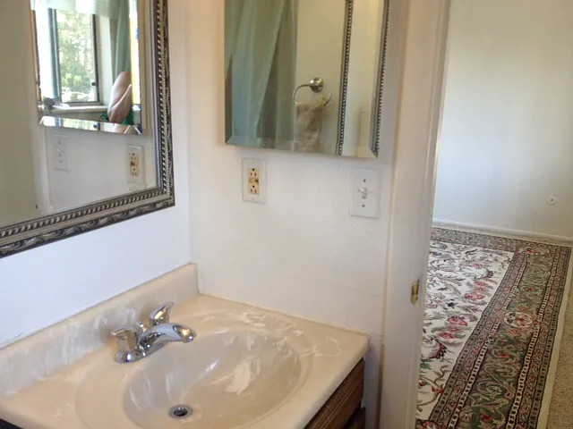Bathroom sink and mirrors, upstairs queen room.