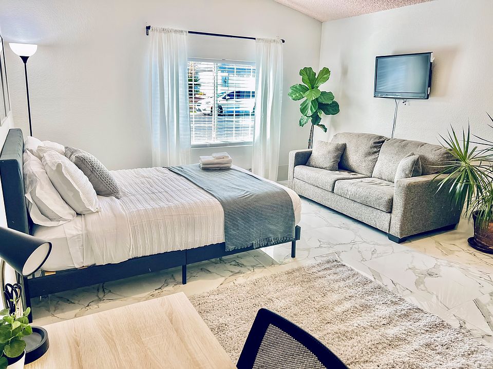 [RM6] with TV and couch. Close to the front door and living room. One of the biggest rooms w/a view of the front house.