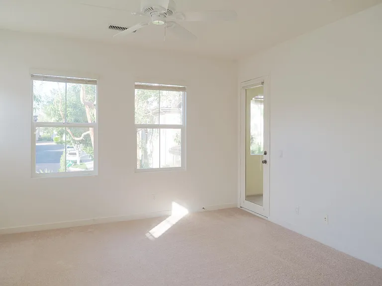 Spacious master bedroom and door leading out to balcony