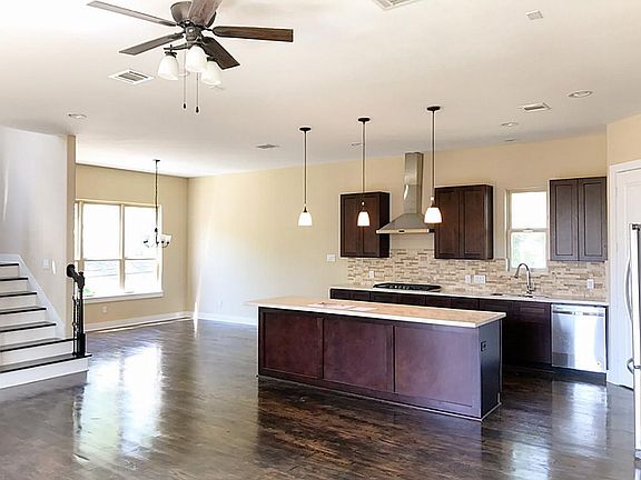 Dining room  flows from the  kitchen with windows facing  Eli St.
