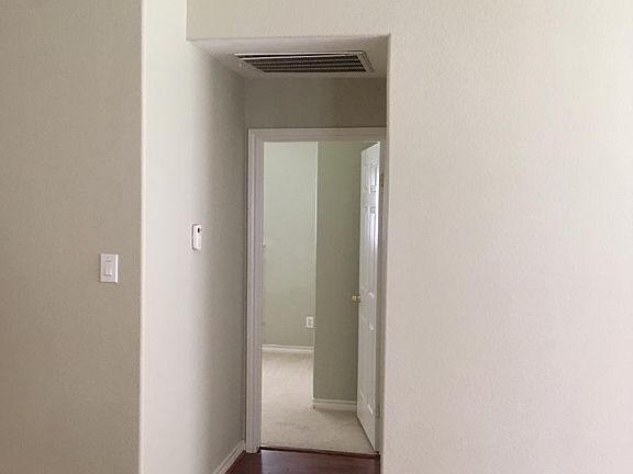 View from Family room, with laminate floor, into bedroom 2. There is no longer carpeting anywhere in the house as of 2021 January.