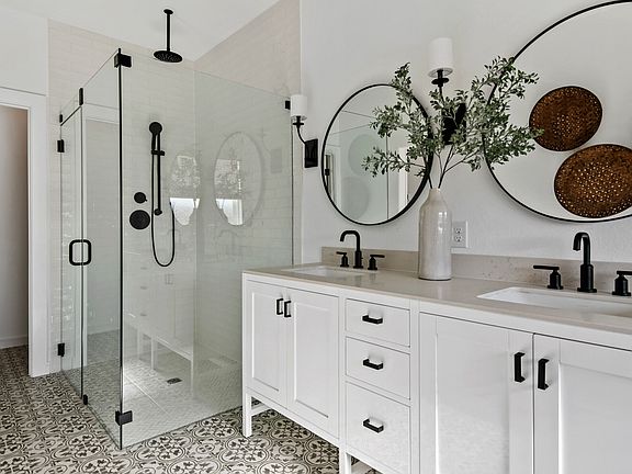 Primary bath with freestanding vanity and glass shower enclosure