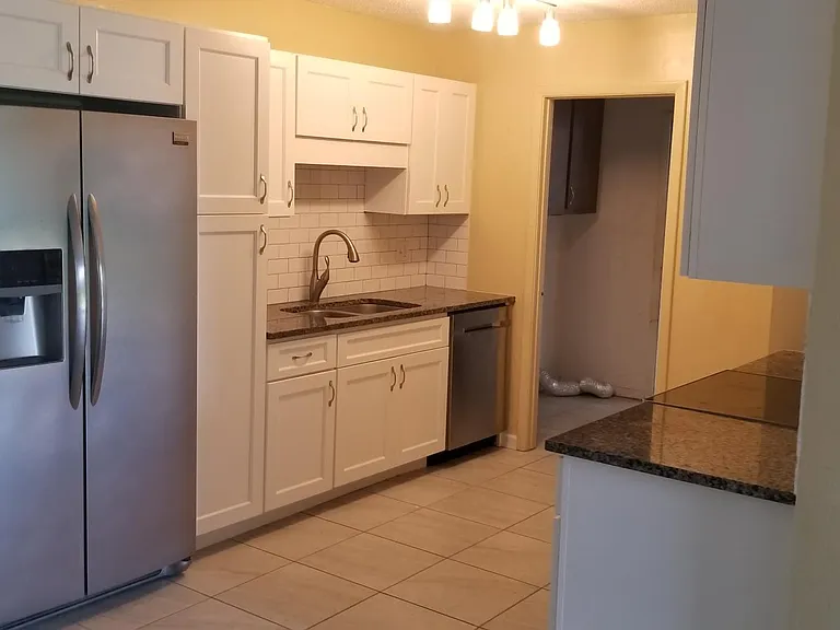 Beautiful new kitchen with stainless steel appliances and gr