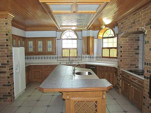 GRAND ENTRY WITH DOUBLE BALCONIES, STAINED GLASS WINDOWS AND LOTS OF NATURAL WOOD