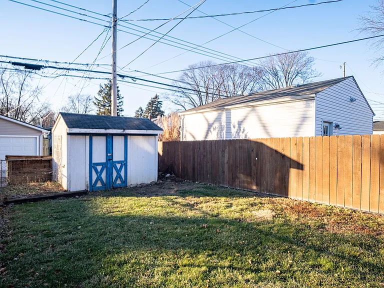 Fully fenced backyard with storage shed