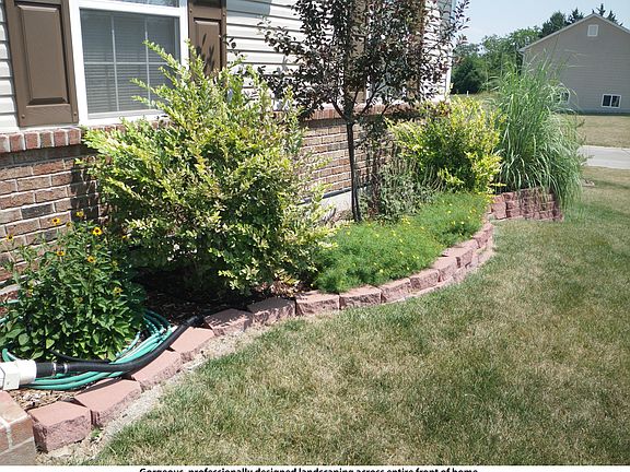 Gorgeous, professionally designed landscaping across entire front of home.