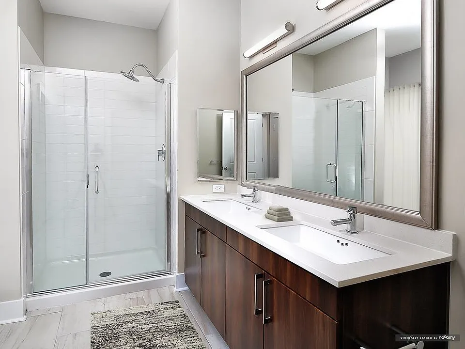 Signature Collection bath with oak cabinetry, white quartz countertops, and hard surface flooring