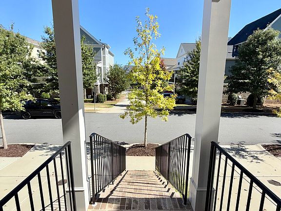 Welcome Home!
Charming front entry with brick steps and modern black railings, offering a warm welcome into this luxury townhome.