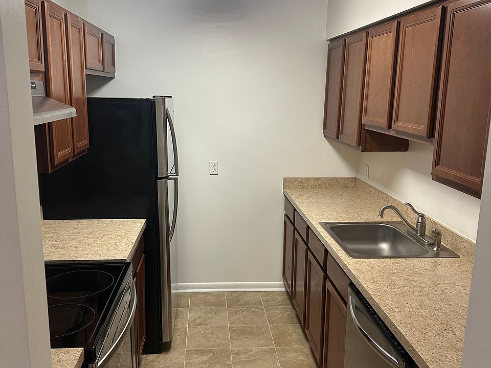 "Efficient kitchen with ample cabinet storage and full-size appliances."