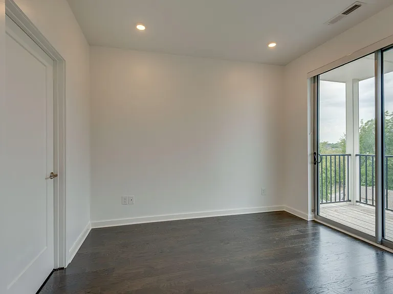 Master Bedroom with Glass Sliding Doors and Walkout Deck.