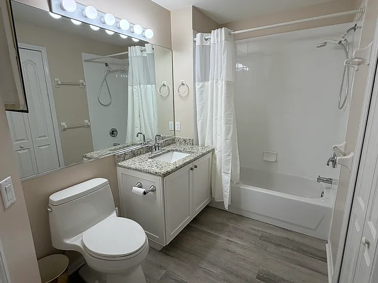 Upgraded (new) cabinets, granite, sinks and faucet. All glass shower doors. Premium vinyl flooring.