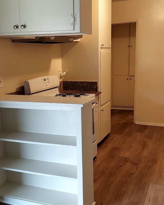 Dining Area & Kitchen with vinyl wood flooring throughout.