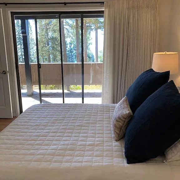 Lake views and lower deck access from bedroom.